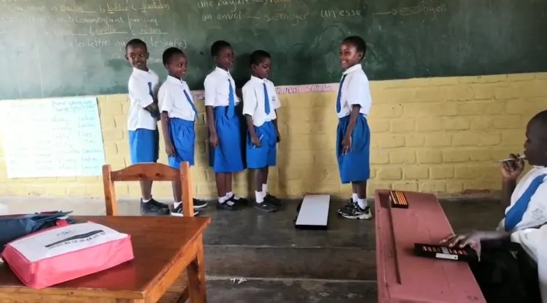 Shenmo Education Rwanda — In-class demonstration: pupils presenting at the board during an abacus lesson.