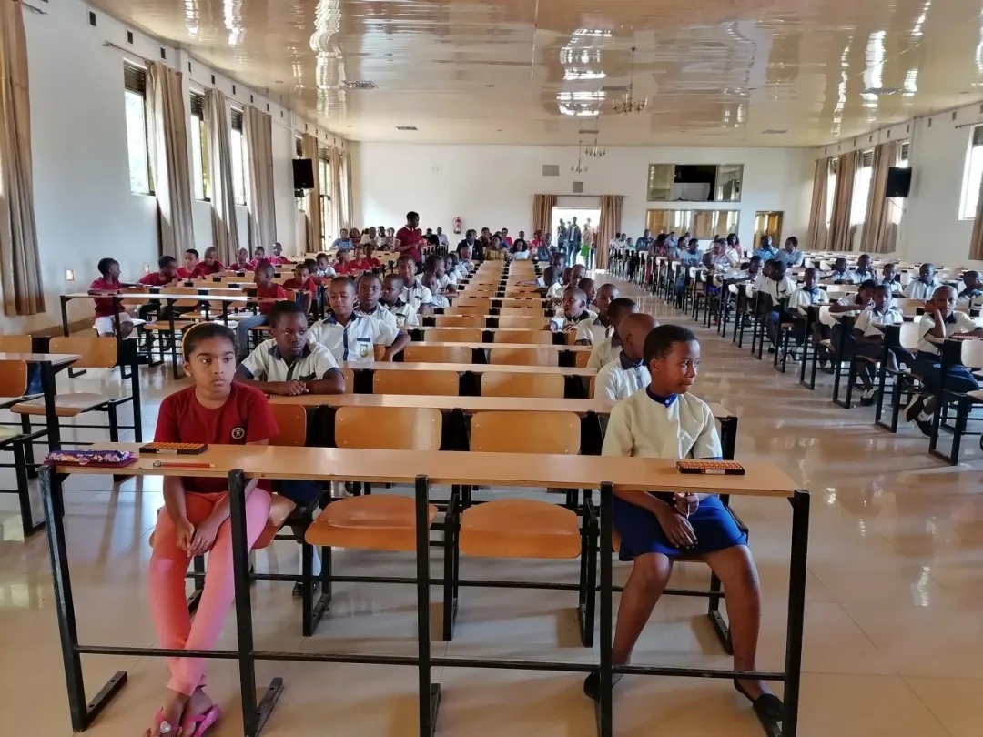 Shenmo Education Rwanda — National competition hall: participants seated with abacuses for Abacus Mental Math.