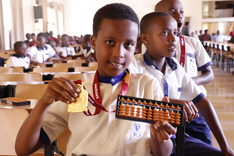 Shenmo Education Rwanda — Early competition milestone: students at a Shenmo Abacus Mental Math event.