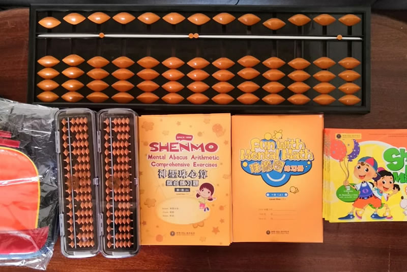Shenmo Education Rwanda — Six progressive levels: abacus and curriculum materials used in Abacus Mental Math training.